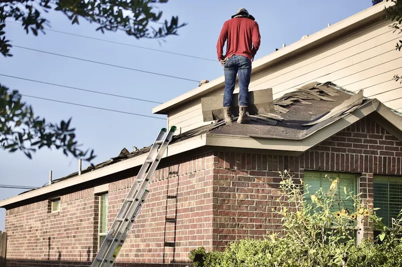 Professional roofer working on a residential roof in Sunrise Golf Village West